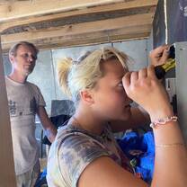 a student uses as screwdriver to work on wiring under close supervision
