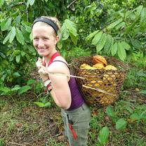 student carrying basket of fruit on her back in the rainforest