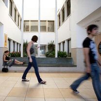 Students sitting and walking through the academic center