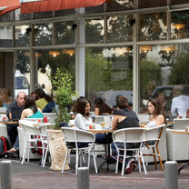 Students sit at an outside cafe table