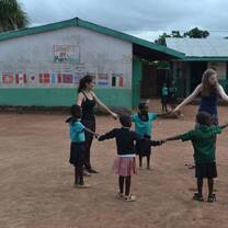 Ghana teen volunteers with children