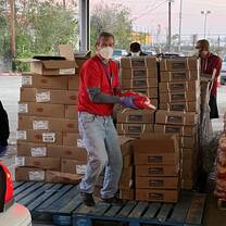 Volunteers loading food into families' cars
