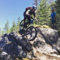 Student learning bike skills on slick rock