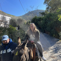 student on donkey in greece