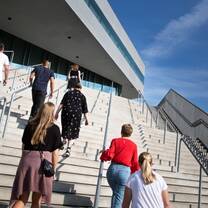 Students walking up the stairs of the Navitas building
