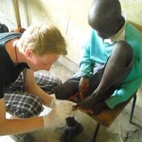 a medical volunteer removing jiggers in one of the students