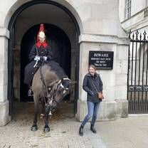 Buckingham Palace guard and his horse with a student. 