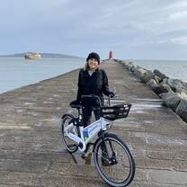 Cyclist posing infront of lighthouse