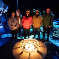 Youth standing around a campfire