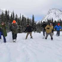 Youth running on snowshoes towards camera