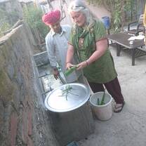 Volunteer learning the techniques of making Ayurveda medicine