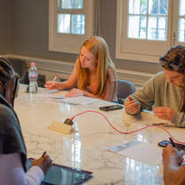 Sage Corps interns working together on their group presentation