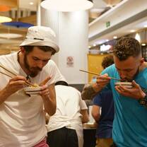 Two students enjoy local food in Chengdu.