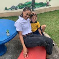 Student teacher with student on the playground