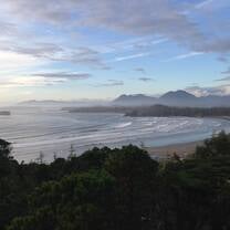 a wide angle landscape photo of the ocean and mountains