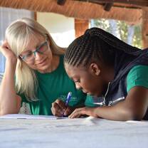 Volunteer and kid doing survey