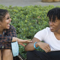 two students laugh together 