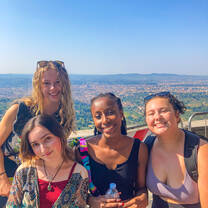 students pose in front of a vast view in tuscany