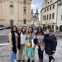 students pose in front of castle in prague
