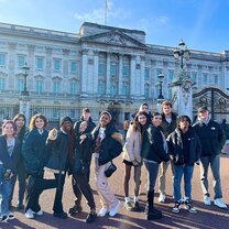 large group of students pose in front of building in london