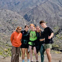 students pose in front of volcan turrialba in costa rica