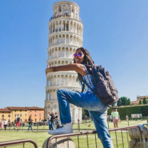 student hugs leaning tower of pisa