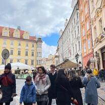 crowd walks on a street in prague