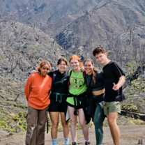 students pose in front of volcan turrialba in costa rica