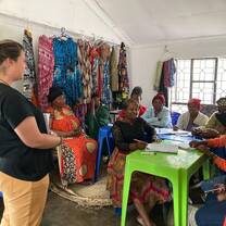 A Volunteer with women during session.
