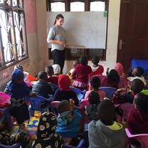 Childcare volunteer in session with children at Childcare center