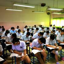 Students in an exam room take a test