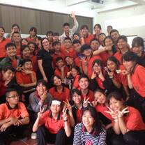 A teacher stands with their Thai Highschool class