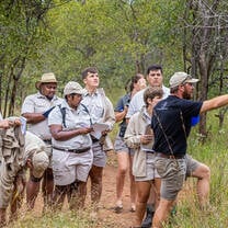 Students learning all about botany in the bush from their trainer.