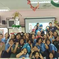 A teacher stands in a group photo with their Thai Highschool class