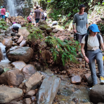 students hiking to waterfall