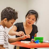 Woman helping child with homework