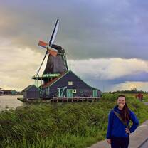 Student by windmill in Amsterdam