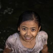 local village indonesian little girl smiling at me