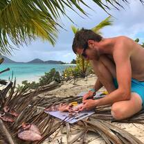 Volunteer cleaning and preparing invasive lionfish.