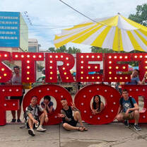 interns in front of a street food sign