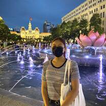 intern in HCMC in front of a fountain