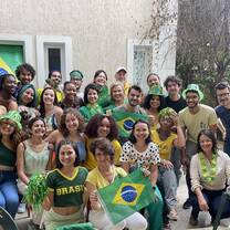 Students, faculty, and staff posing for a photo during a World Cup 2022 watch party