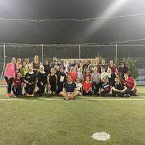 Students and local jiran posing for a photo after playing a pickup game of soccer