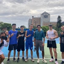 A group of students posing for a picture on a basketball court