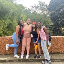 A group of four students posing for a picture at the Cali zoo