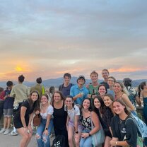 A group of CET Florence students posing in front of a sunset
