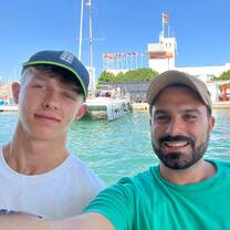 selfie of two students sitting on a boat