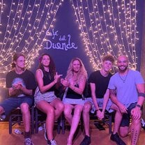 5 students sitting on a bench