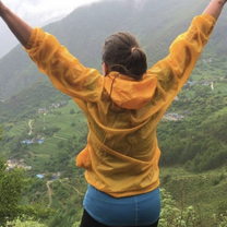 Teacher jumping for joy in the mountains in China