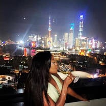 Teacher enjoying a drink with an amazing view of Shanghai 